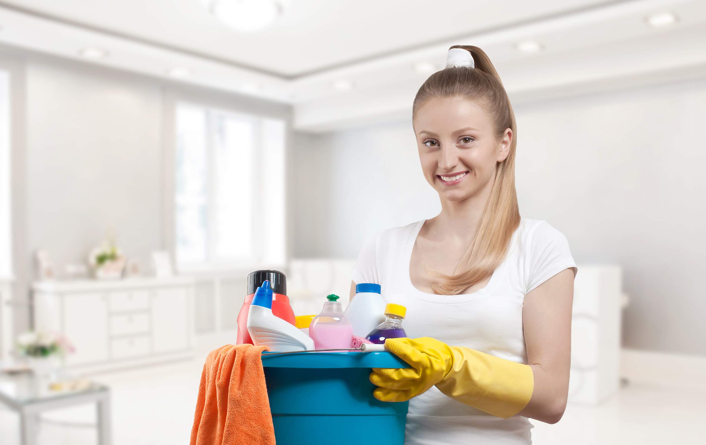 house cleaner holding bucket of products